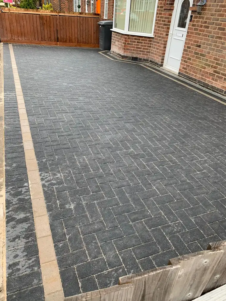 Charcoal herringbone block driveway with buff edging course