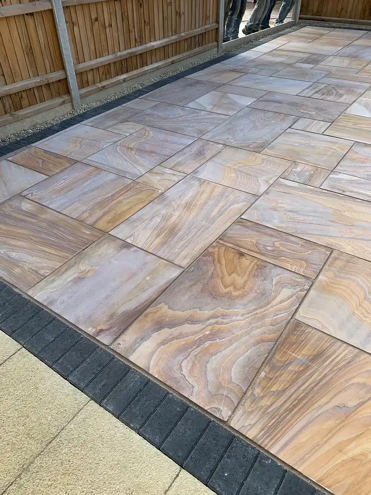 Rainbow sandstone patio with charcoal border