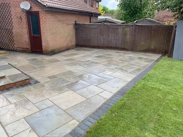 Sandstone patio cut around a new lawn