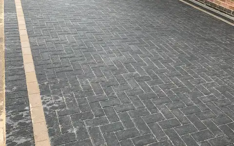 Charcoal herringbone block driveway with buff edging
