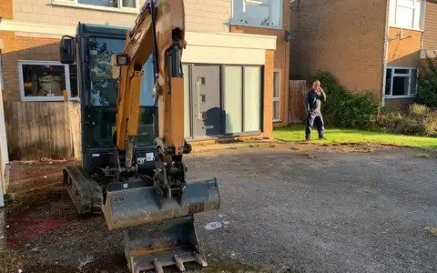 Excavator digging out a driveway ready for a rebuild