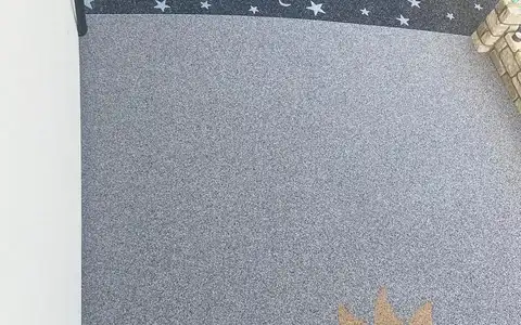 Grey resin bound surfacing with sun and star inlays