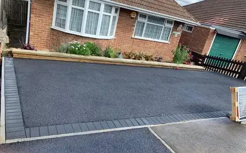Tarmac driveway with charcoal block border at a bungalow