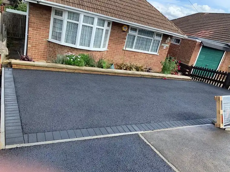 Tarmac driveway with charcoal block border at a bungalow