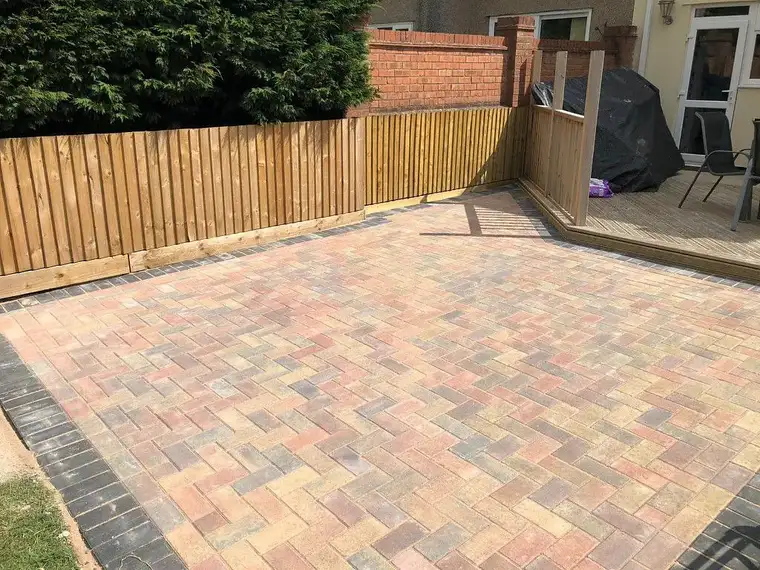 Multi-tone block paved patio with timber fence and decking
